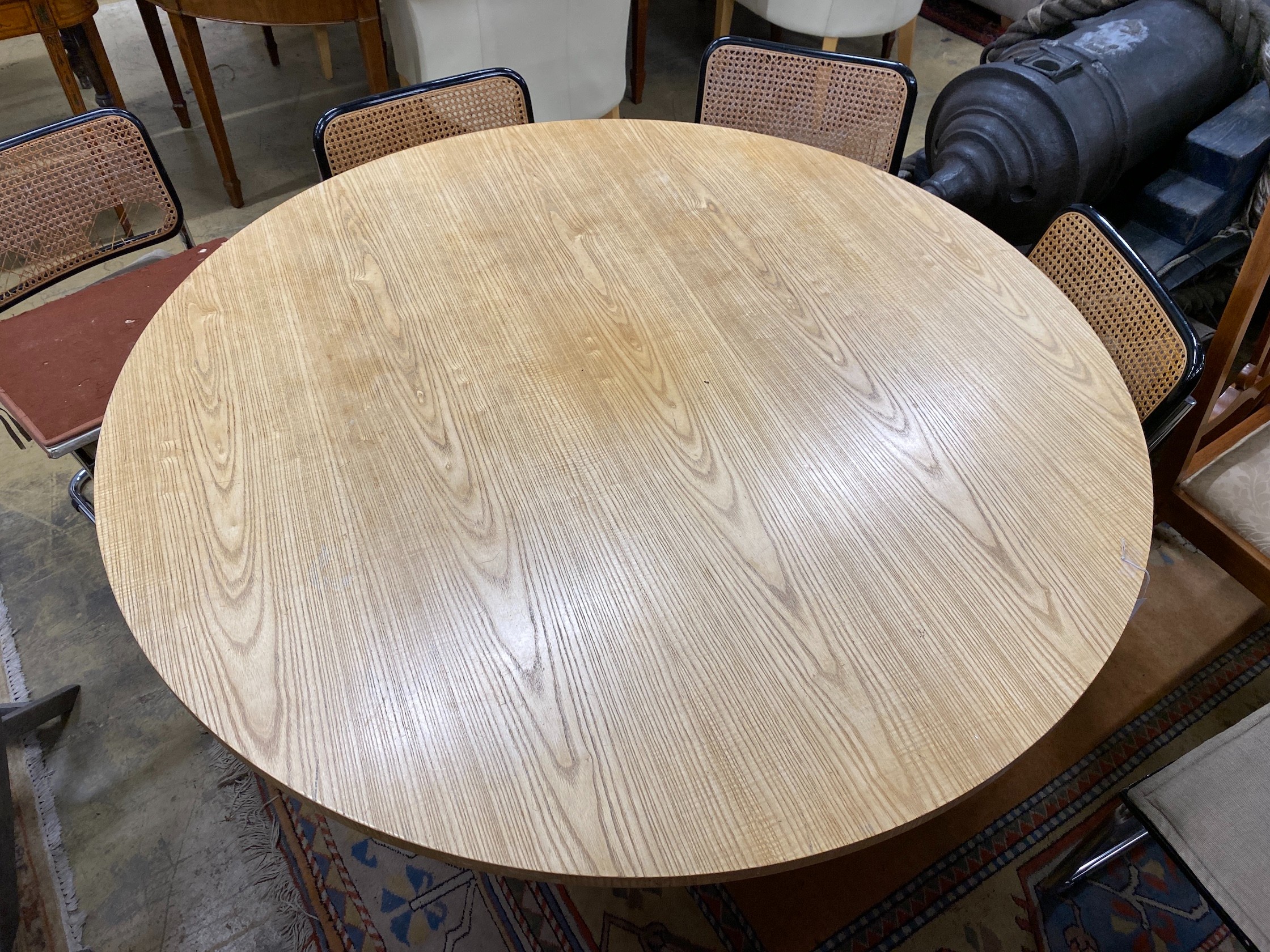 A Conran retailed circular pale ash dining table, on three pillars and circular plinth foot, diameter 150cm, height 73cm